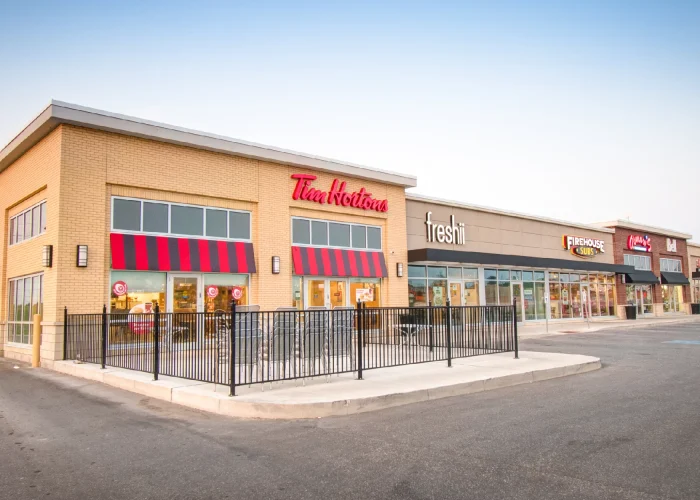 Yonge Green Lane Common, East Gwillimbury – Tim Hortons and Freshii storefronts in a retail row