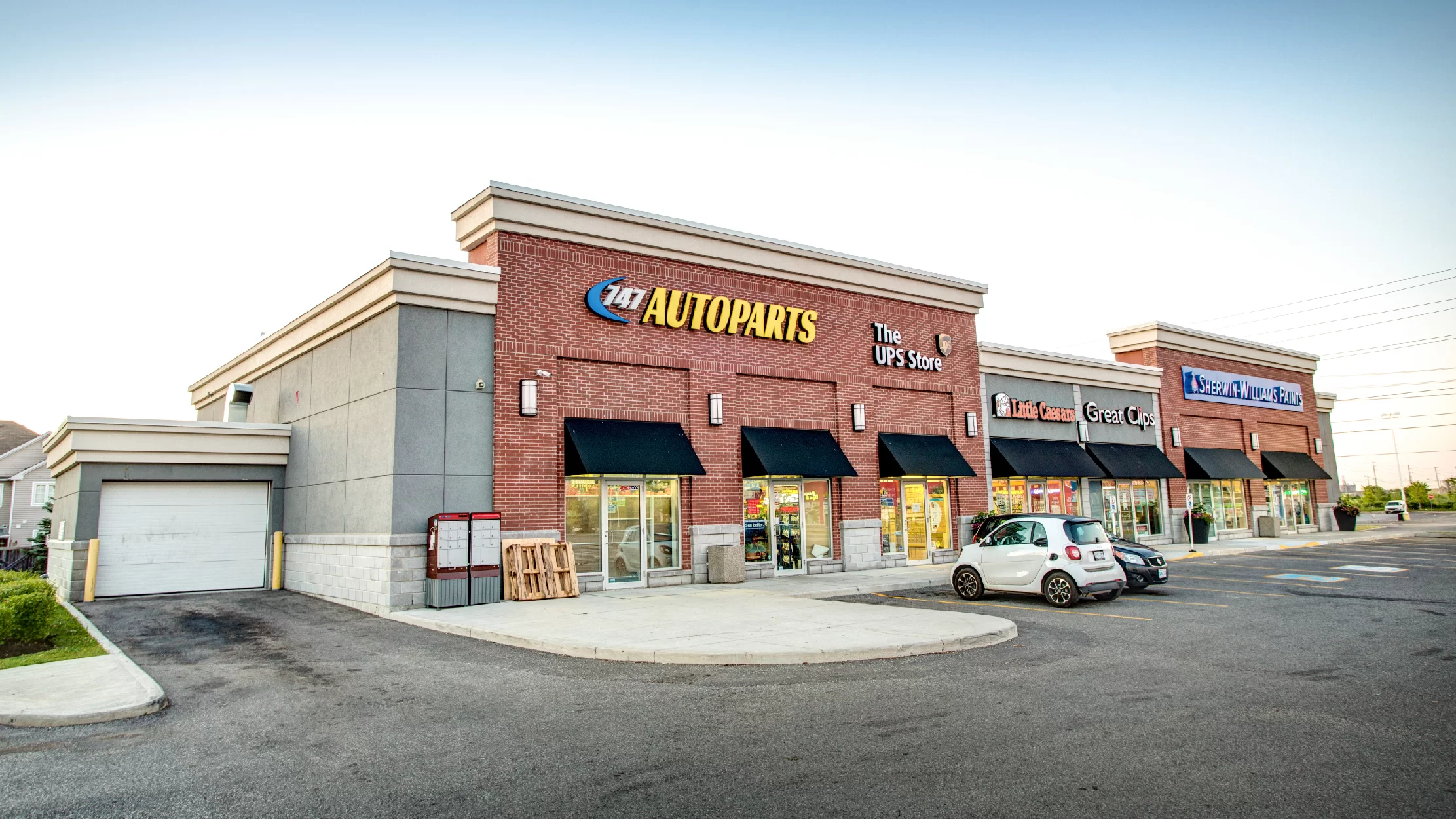 Markham Gate, Markham – brick plaza storefronts with 247 Autoparts and The UPS Store