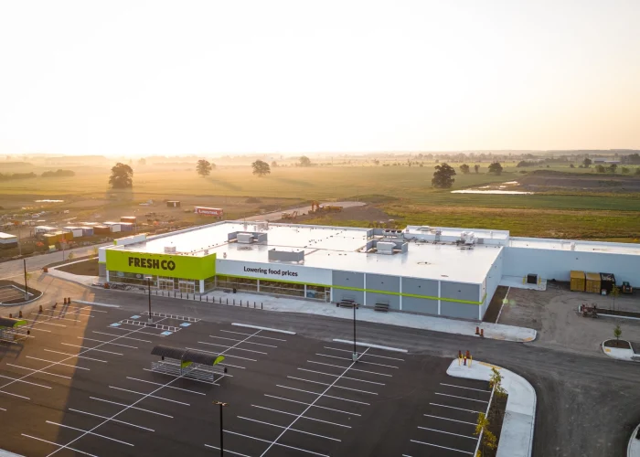 Mazmik Marketplace, Milton – aerial view of the FreshCo store and parking lot at sunrise