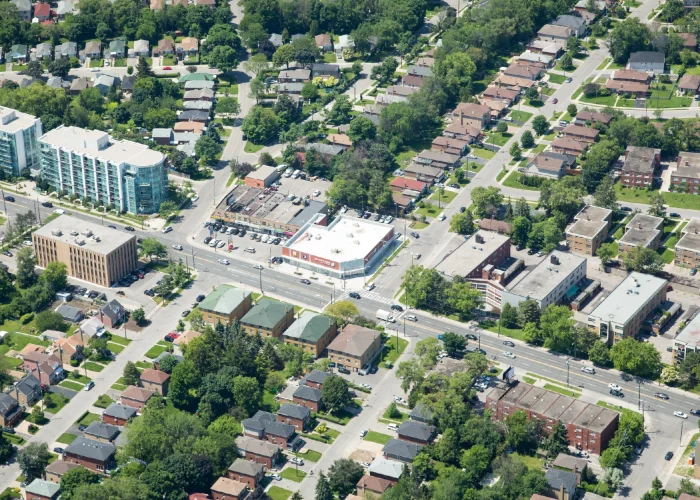 Bathurst St & Invermay Ave, Toronto – aerial view of a corner plaza among houses and a mid-rise