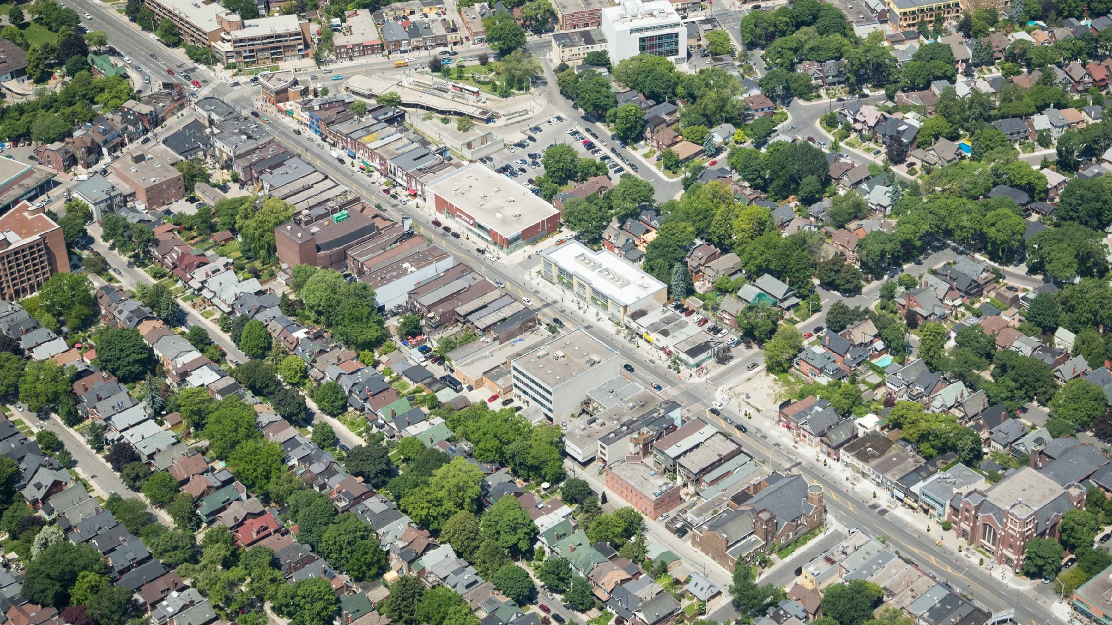 Danforth Ave & Ellerbeck St, Toronto – aerial view of a low-rise commercial strip and surrounding homes