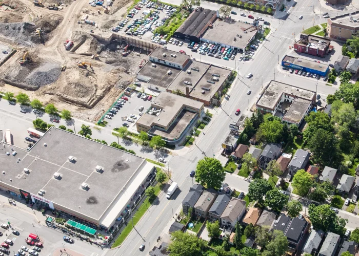Eglinton Ave E & Laird Dr, Toronto – aerial view of the plaza beside an excavated construction site