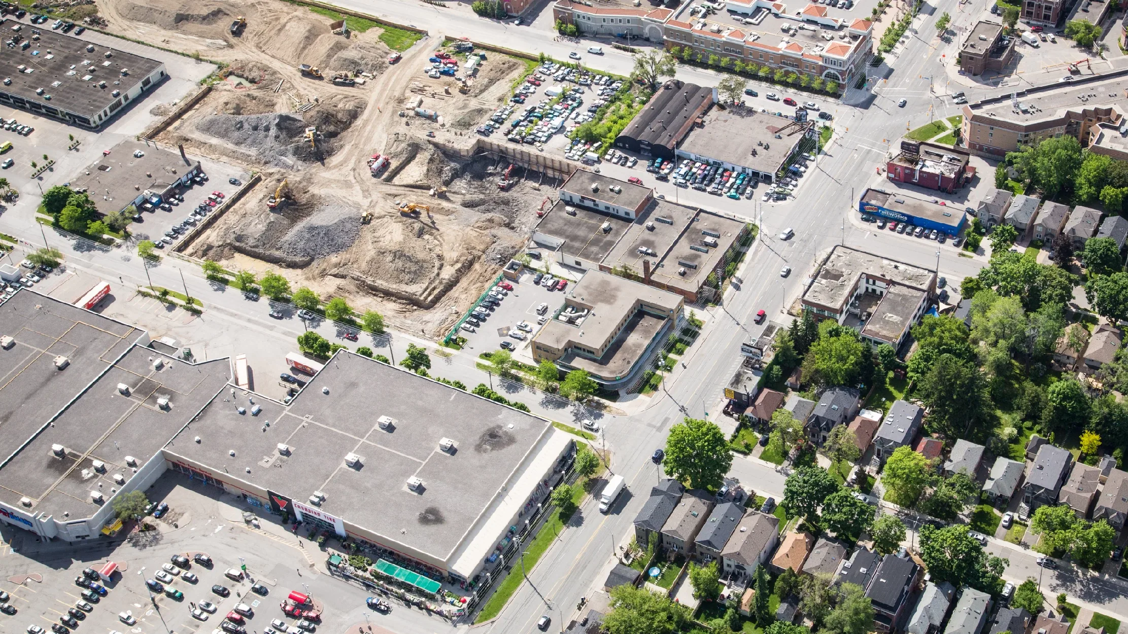 Eglinton Ave E & Laird Dr, Toronto – aerial view of the plaza beside an excavated construction site