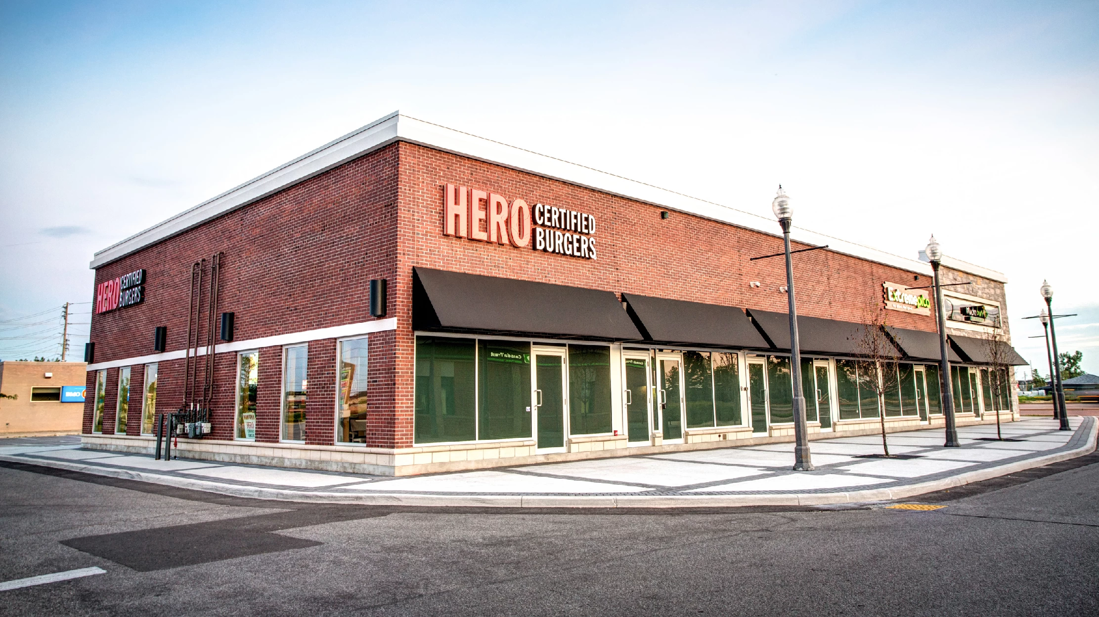 Vellore Village Phase I, Vaughan – Hero Certified Burgers corner storefront at dusk