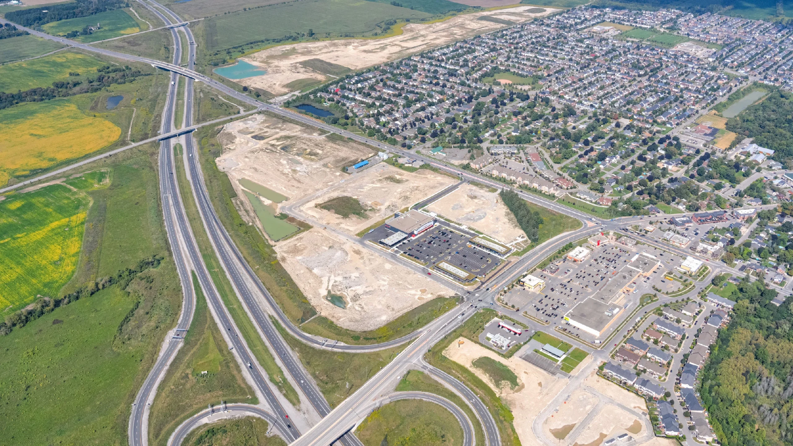 Brooklin Boroughs Phase I, Brooklin – aerial view of the graded site beside a highway interchange