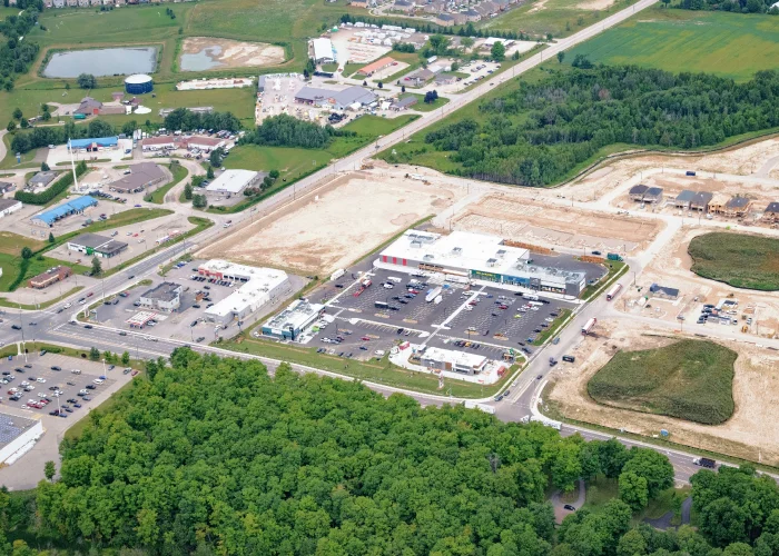 Emerald Crossing Phase I & II, Shelburne – aerial view of the plaza with graded land beside it
