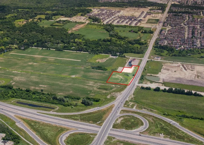 Taunton Rd W & Des Newman Blvd, Whitby – aerial view of the undeveloped site outlined in red beside a highway