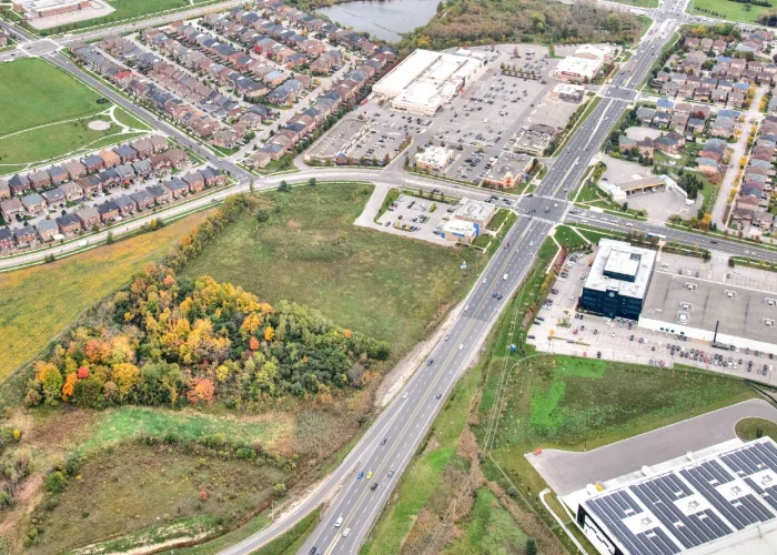 Cachet Village Phase II, Markham – aerial view of the undeveloped site beside the highway and warehouses