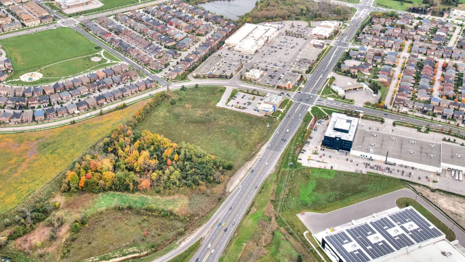 Cachet Village Phase II, Markham – aerial view of the undeveloped site beside the highway and warehouses