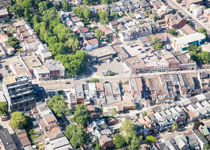 Dundas St West and Ossington Ave, Toronto – aerial view of a low-rise commercial strip and surrounding homes