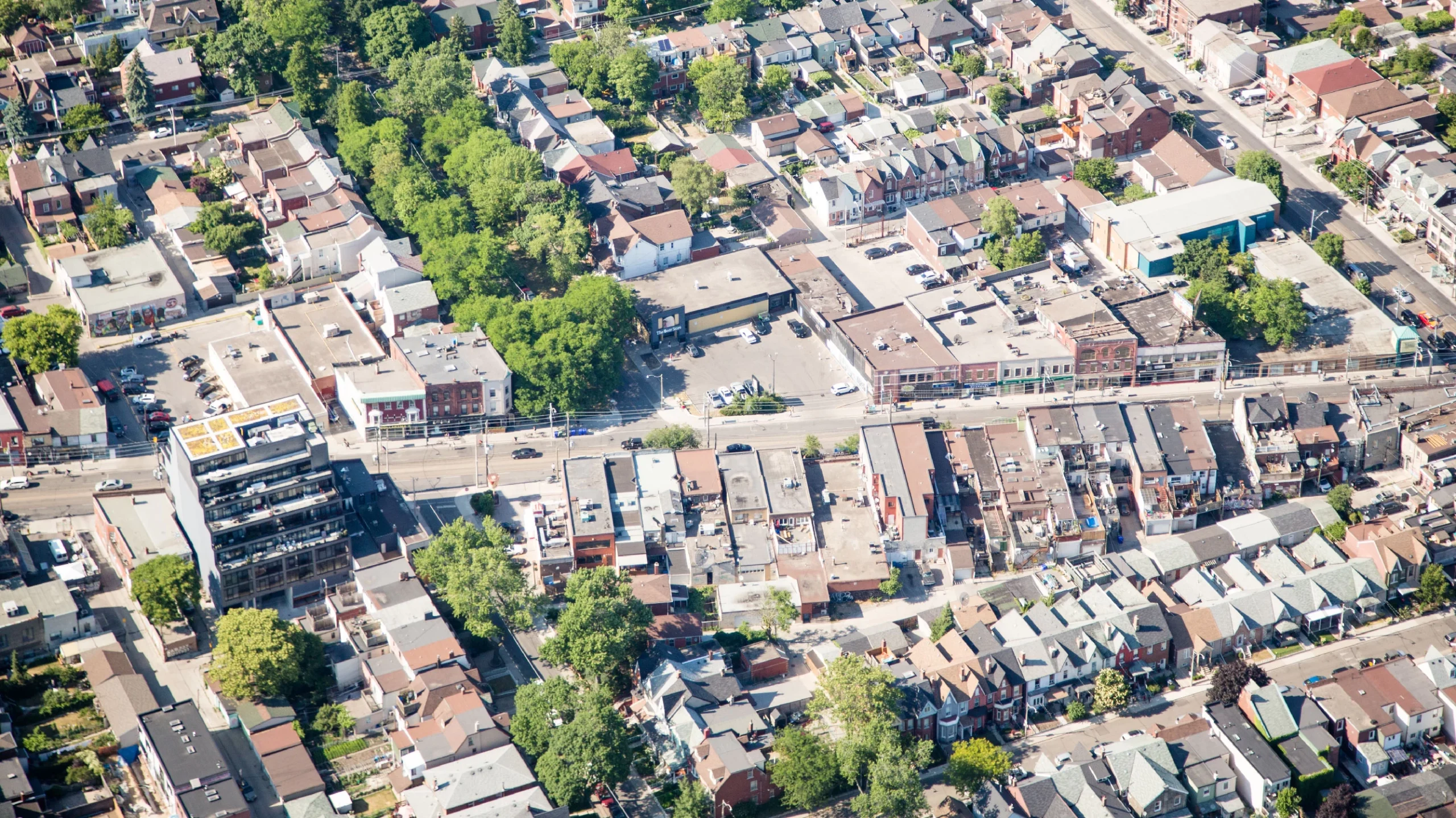 Dundas St West and Ossington Ave, Toronto – aerial view of a low-rise commercial strip and surrounding homes