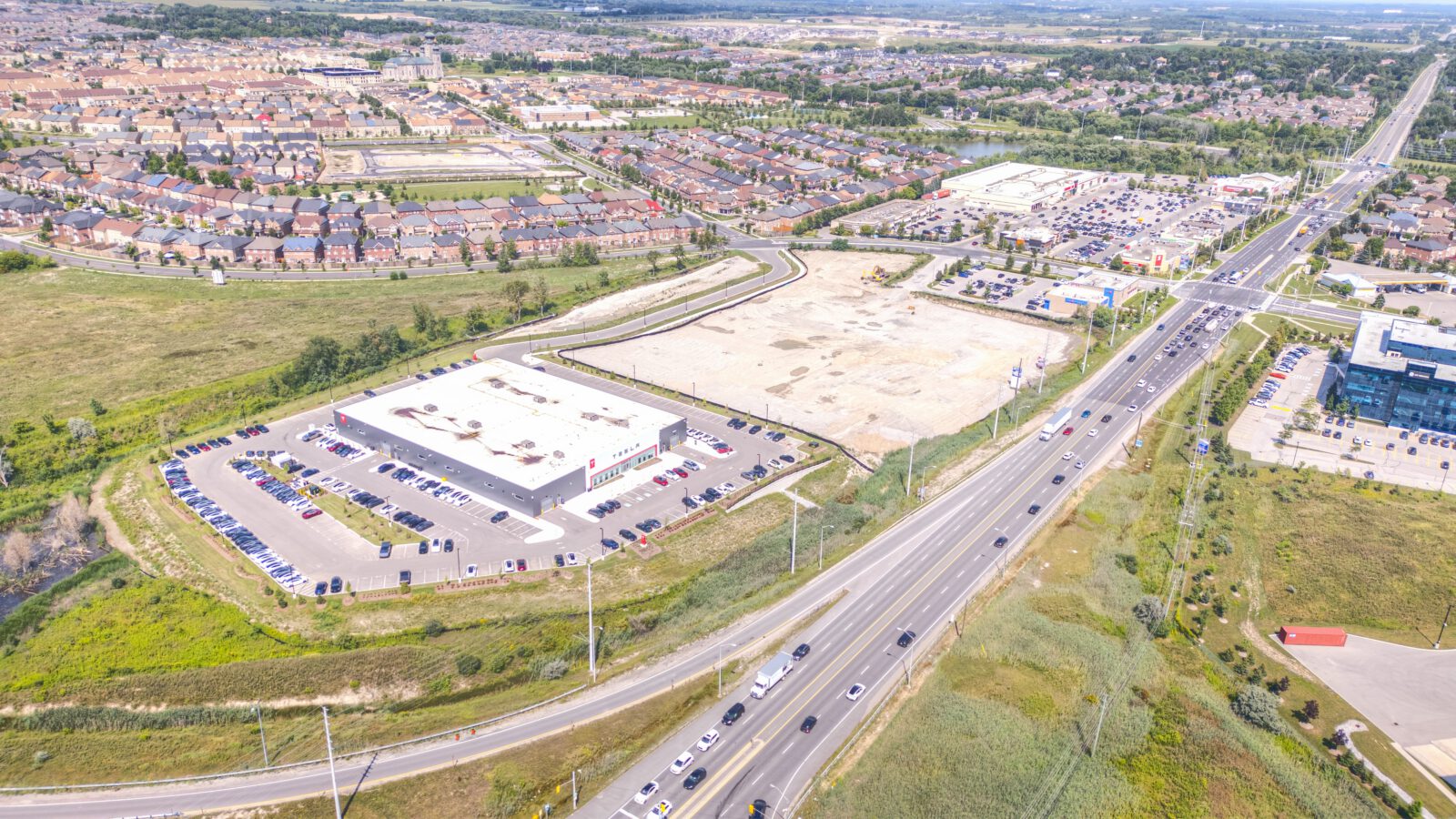 Cachet Village Phase II, Markham – aerial view of a white big-box building beside the highway