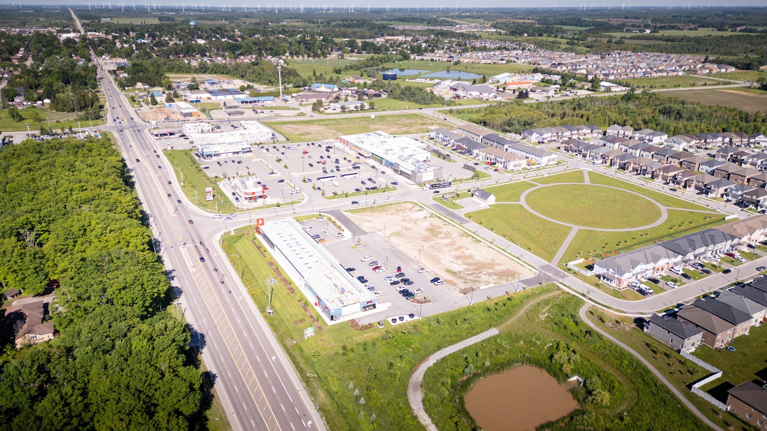 Emerald Crossing Phase I & II, Shelburne – aerial view of the plaza, highway and new homes
