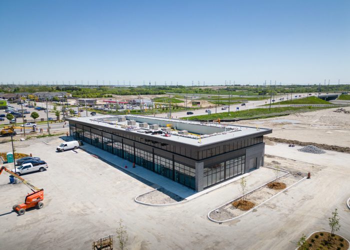 Brooklin Boroughs Phase I, Brooklin – aerial view of a retail building with a boom lift in the lot