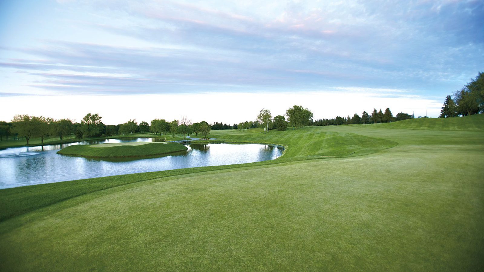 Upper Unionville – golf course fairway and pond under a cloudy sky