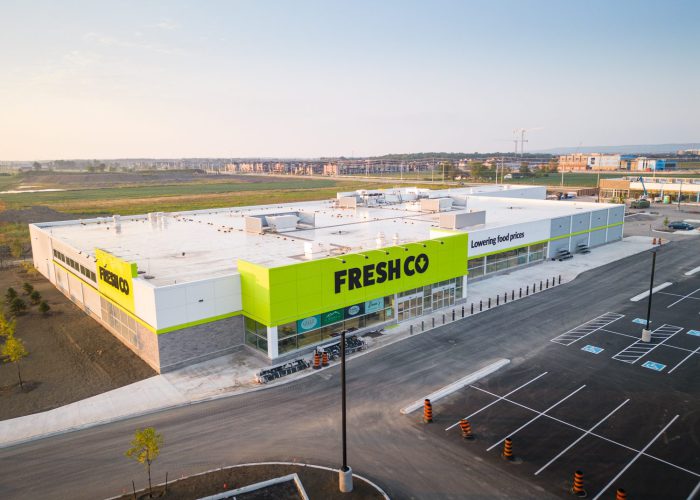 Mazmik Marketplace, Milton – aerial view of the FreshCo store and parking lot