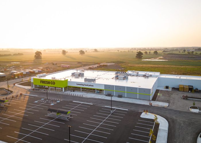 Mazmik Marketplace, Milton – aerial view of the FreshCo store and parking lot at sunrise