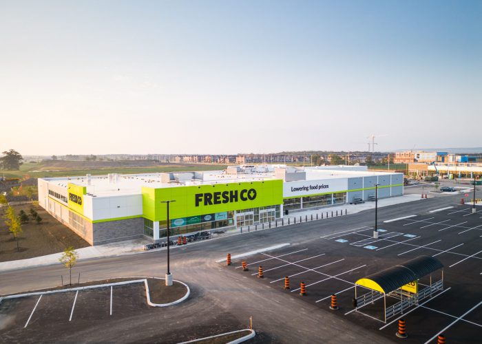 Mazmik Marketplace, Milton – aerial view of the FreshCo store, parking lot and cart corral