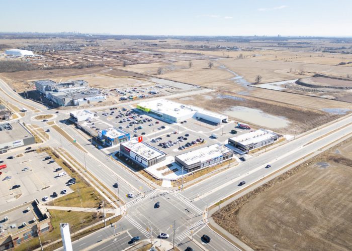 Mazmik Marketplace, Milton – aerial view of the plaza and intersection with open land beyond