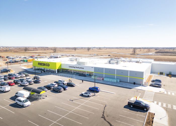 Mazmik Marketplace, Milton – aerial view of the FreshCo store and parking lot with cars
