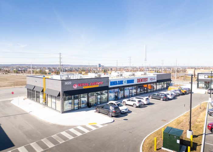 Mazmik Marketplace, Milton – elevated view of a retail strip with parked cars