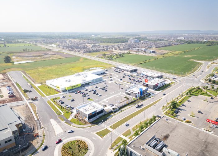 Mazmik Marketplace, Milton – aerial view of the plaza, parking lot and roundabout with fields