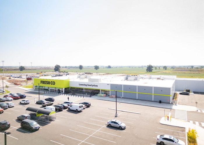 Mazmik Marketplace, Milton – aerial view of the FreshCo store and parking lot with cars