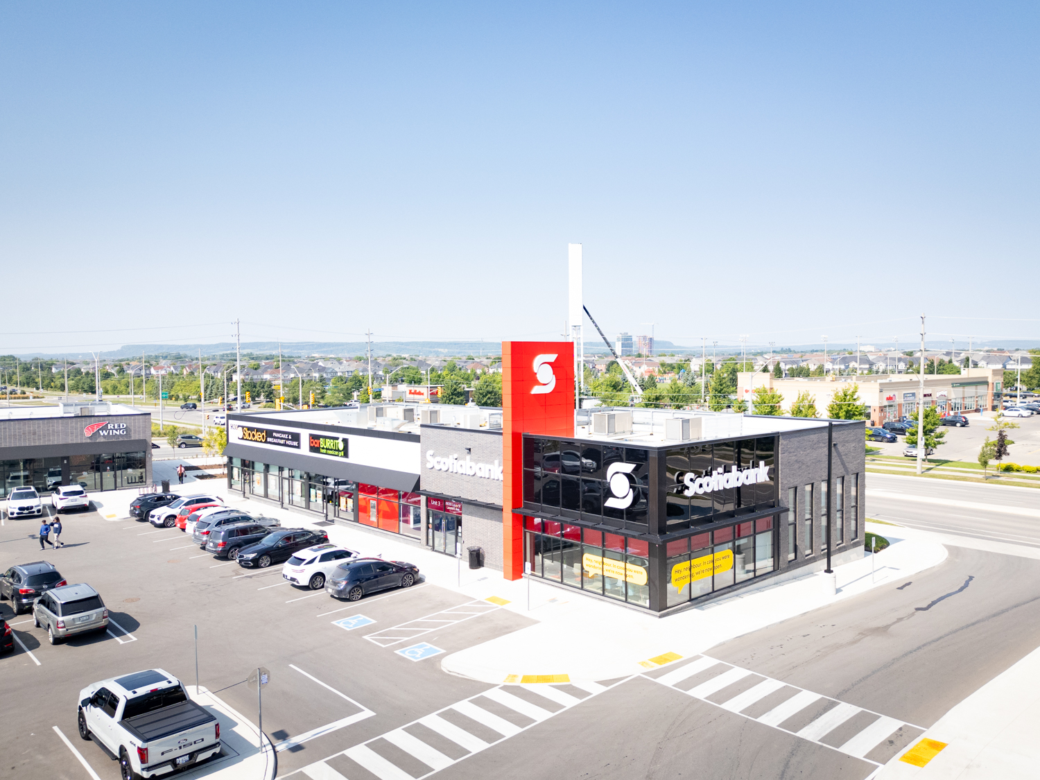 Mazmik Marketplace, Milton – aerial view of the retail row and Scotiabank at the plaza entrance
