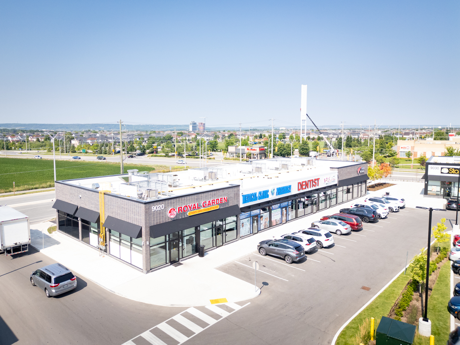 Mazmik Marketplace, Milton – aerial view of the retail row with Royal Garden and dental office