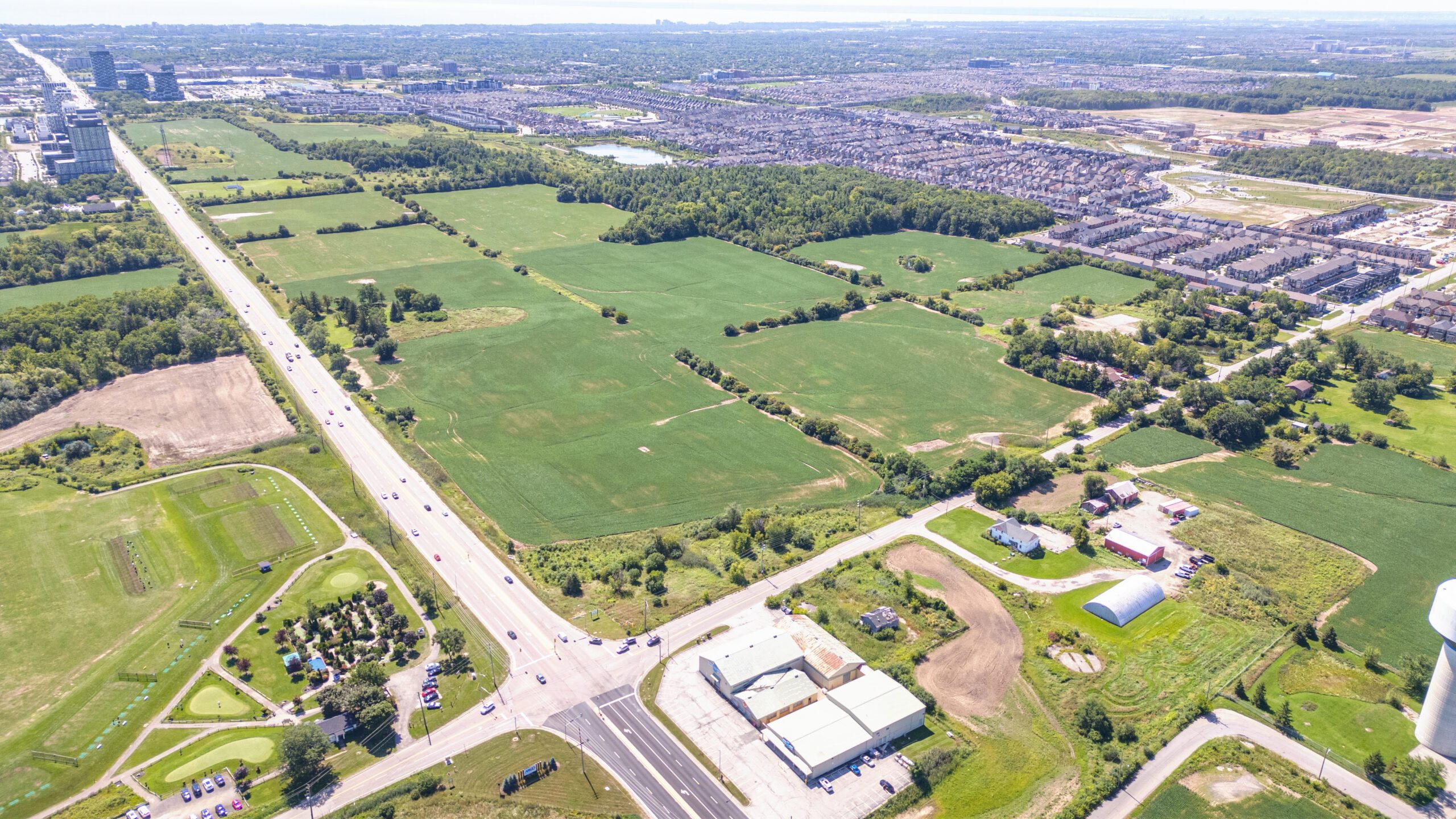 Burnhamthorpe Rd E & Trafalgar Rd, Oakville – aerial view of the undeveloped site with farm fields and roads