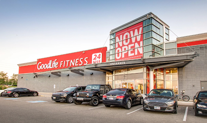 Fieldgate Commercial – GoodLife Fitness entrance with Now Open banner and parked cars