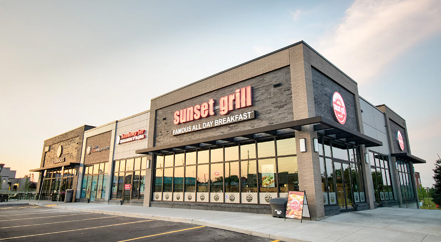 Fieldgate Commercial – Sunset Grill storefront at dusk
