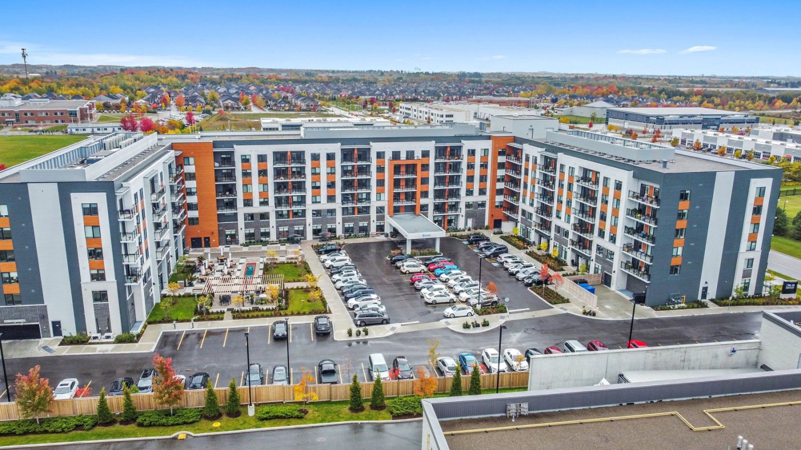 Bloom Stouffville – aerial view of a mid-rise residential building and parking lot